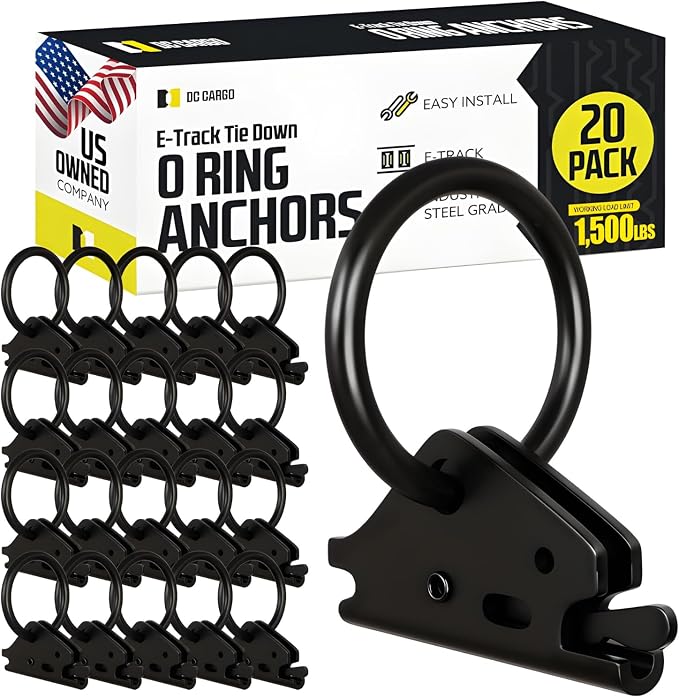 Set of black E-track tie-down O-ring anchors displayed in front of retail packaging on a light gray background. Twenty metal anchor fittings are arranged in rows on the left, while a larger close-up view of a single anchor appears on the right, showing the circular O-ring and E-track mounting mechanism. The packaging behind the anchors features branding from DC Cargo and text including “E-Track Tie Down O Ring Anchors,” “20 Pack,” “Easy Install,” and “1,500 lbs.” A U.S. flag graphic and “US Owned Company” l