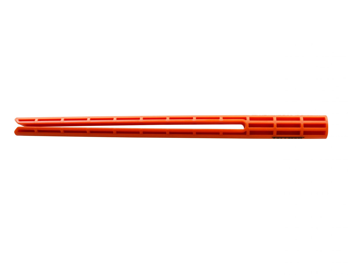 Bright orange plastic slotted tube-like component shown horizontally on a white background. The elongated cylindrical piece has evenly spaced rectangular ventilation openings along its length and a tapered, open-ended tip on the left side. A small section of partially visible printed text appears near the right end.