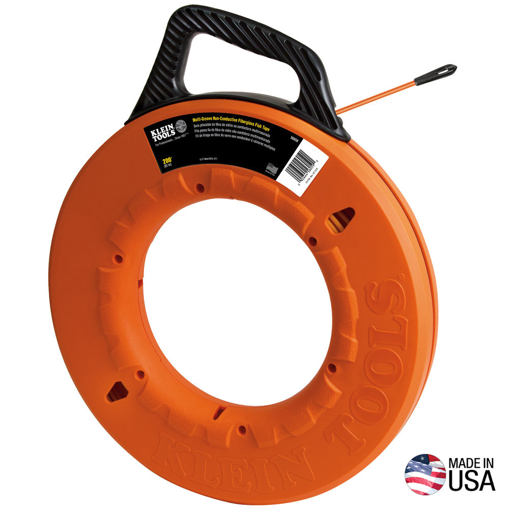 Klein Tools non-conductive fiberglass fish tape housed in a bright orange circular reel with an ergonomic black carry handle. The fish tape extends slightly from the reel and features a leader tip for pulling wire through conduit. The reel is embossed with “KLEIN 1000” and labeled as a 200-foot fiberglass fish tape, with a “Made in USA” emblem shown in the lower-right corner.