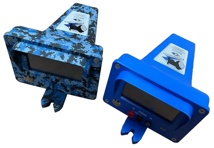 Two electronic device enclosures shown on a plain white background: one in blue digital camouflage and one in solid bright blue. Both have dark display windows and small labels on top.