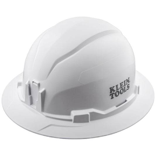 White Klein Tools hard hat shown in a three-quarter front view against a light gray background. The hard hat features a full brim, a smooth molded shell with raised ridges along the top, and accessory mounting slots around the sides. The black “KLEIN TOOLS” logo is printed on the right side of the helmet.